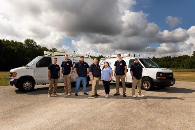 Paul The Plumber team standing with service trucks in Conroe, TX